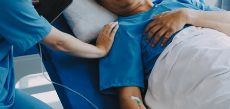 Women Asian doctors hold the patient hand and encourage and provide medical advice While checking the patient health in bed. Concept of Care and compassion, antenatal care, Threatened abortionの写真素材