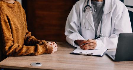 Doctor presenting with patient and checking results on report and prescription about the problem of illness and recommend using medicine, healthcare and medical concept.の写真素材