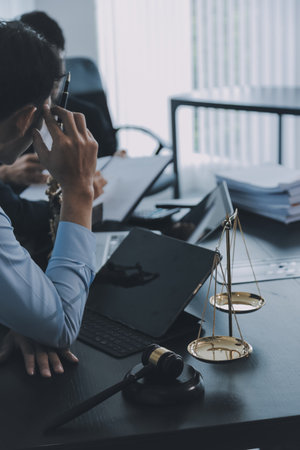Business and lawyers discussing contract papers with brass scale on desk in office. Law, legal...