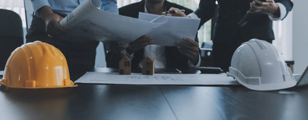 Construction and structure concept of Engineer or architect meeting for project working with partner and engineering tools on model building and blueprint in working site, contract for both companies.の写真素材