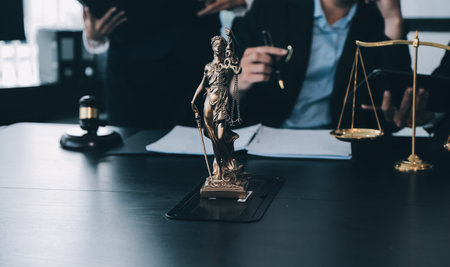 Business and lawyers discussing contract papers with brass scale on desk in office. Law, legal...