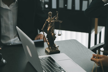 Business and lawyers discussing contract papers with brass scale on desk in office. Law, legal services, advice, justice and law concept picture with film grain effectの写真素材