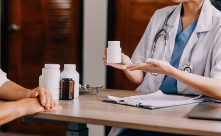 Pharmacist explaining prescription medication to woman in the pharmacy for pharmaceutical healthcare treatment. Medical, counter and female chemist talking to patient on medicine in clinic dispensaryの写真素材