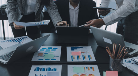 Close up of Business team analyzing income charts and graphs with modern laptop computer. Business analysis and strategy concept.の写真素材