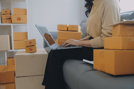 Business woman start up small business entrepreneur SME success .freelance woman working at home with Online Parcel delivery. SME and packaging deliveryconceptの写真素材