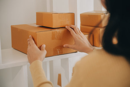 Business woman start up small business entrepreneur SME success .freelance woman working at home with Online Parcel delivery. SME and packaging deliveryconceptの写真素材