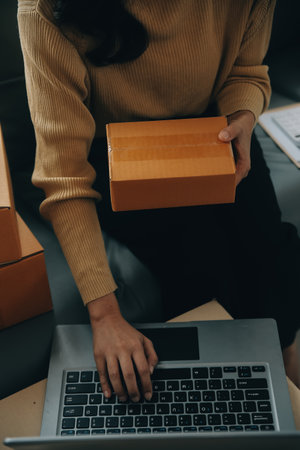 Business woman start up small business entrepreneur SME success .freelance woman working at home with Online Parcel delivery. SME and packaging deliveryconceptの写真素材