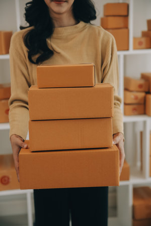 Business woman start up small business entrepreneur SME success .freelance woman working at home with Online Parcel delivery. SME and packaging deliveryconceptの写真素材