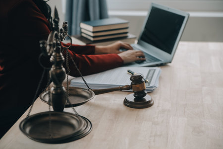 Justice and law concept.Male judge in a courtroom with the gavel, working with, computer and docking...