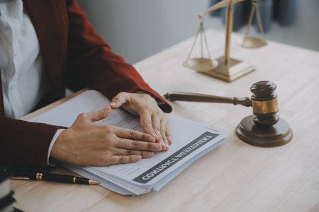 Business and lawyers discussing contract papers with brass scale on desk in office. Law, legal...