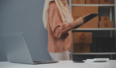Starting small businesses SME owners female entrepreneurs Write the address on receipt box and check online orders to prepare to pack the boxes, sell to customers, sme business ideas online.の写真素材
