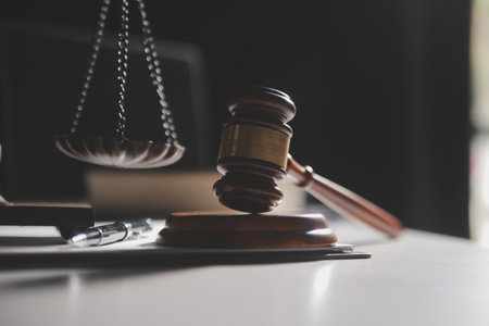Business and lawyers discussing contract papers with brass scale on desk in office. Law, legal services, advice, justice and law concept picture with film grain effectの写真素材