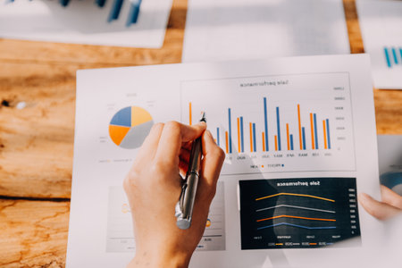 Financial analysts analyze business financial reports on a digital tablet planning investment...