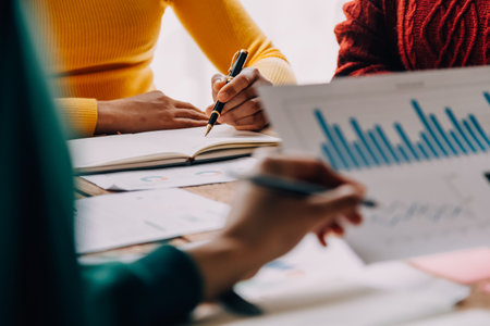 Brainstorming Collaboration and successful partnership analysis by Young business Asian people working in an office workspaceの写真素材