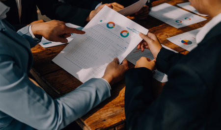 Brainstorming Collaboration and successful partnership analysis by Young business Asian people working in an office workspaceの写真素材