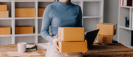 Entrepreneurs Small Business SME Independent men work at home Use smartphones and laptops for commercial checking, online marketing, packing boxes, SME sellers, concept, e-commerce team, online salesの写真素材