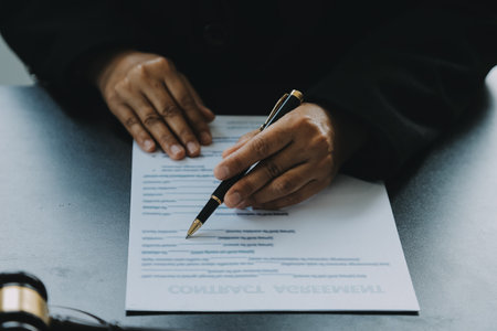 Judge gavel with Justice lawyers having team meeting at law firm in background. Concepts of law.の写真素材