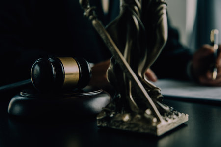 Judge gavel with Justice lawyers having team meeting at law firm background. Concepts of Law and Legal services.の写真素材