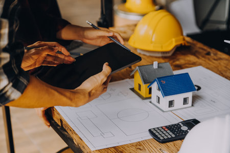 Construction concept of Engineer and Architect working at Construction Site with blue printの写真素材