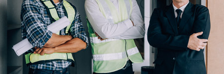 Diverse Team of Specialists Use Tablet Computer on Construction Site. Real Estate Building Project with Civil Engineer, Architect, Business Investor and General Worker Discussing Plan Details.の写真素材
