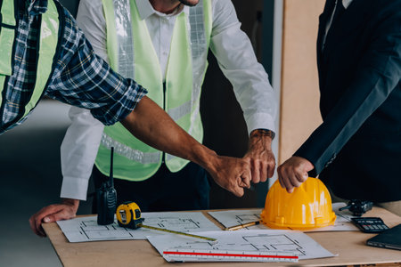 Diverse Team of Specialists Use Tablet Computer on Construction Site. Real Estate Building Project...
