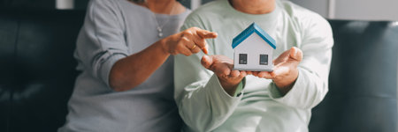 Happy mature couple using laptop at homeの写真素材