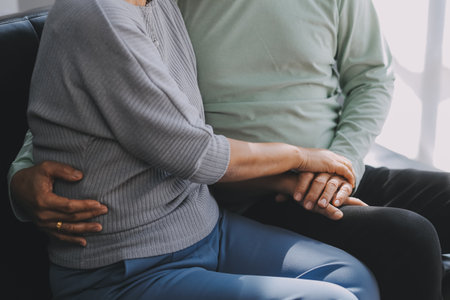 Happy mature couple using laptop at homeの写真素材