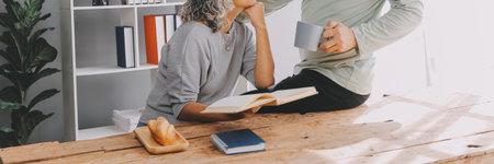 Happy mature couple using laptop at homeの写真素材