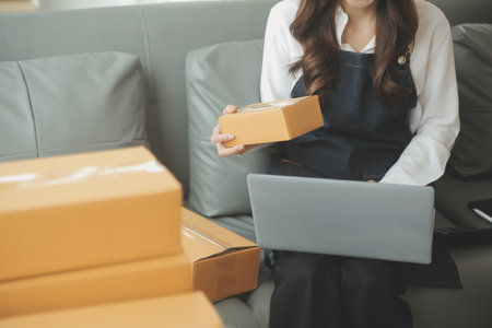 Business woman start up small business entrepreneur SME success .freelance woman working at home with Online Parcel delivery. SME and packaging deliveryconceptの写真素材