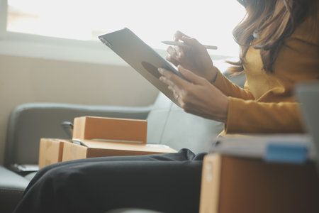 Business woman start up small business entrepreneur SME success .freelance woman working at home with Online Parcel delivery. SME and packaging deliveryconceptの写真素材