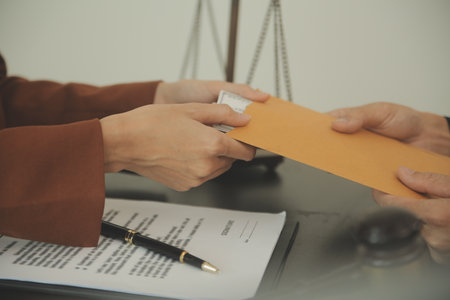 Business and lawyers discussing contract papers with brass scale on desk in office. Law, legal...