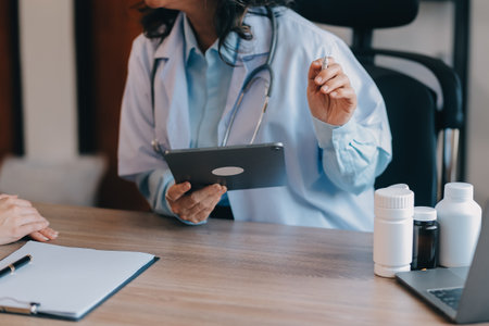 Asian doctor woman visited patient woman to diagnosis and check up health at home or private hospital. Female patient explain health problem and symptoms to doctor .Health care premium service at homeの写真素材