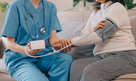 Asian doctor woman visited patient woman to diagnosis and check up health at home or private hospital. Female patient explain health problem and symptoms to doctor .Health care premium service at homeの写真素材