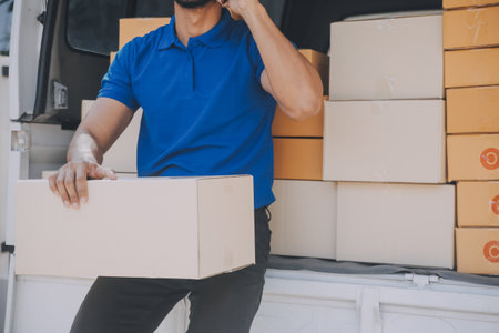 Startup small business entrepreneur of freelance Asian woman using a laptop with box Cheerful success Asian woman her hand lifts up online marketing packaging box and delivery SME idea conceptの写真素材