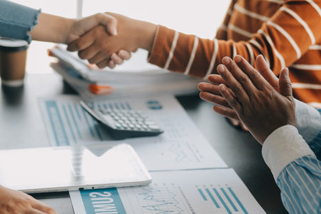 Business handshake for teamwork of business merger and acquisition,successful negotiate,hand shake,two businessman shake hand with partner to celebration partnership and business deal conceptの写真素材