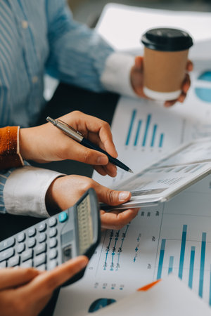 Financial analysts analyze business financial reports on a digital tablet planning investment...