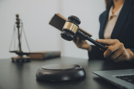 Judge gavel with Justice lawyers having team meeting at law firm background. Concepts of Law and Legal services.の写真素材