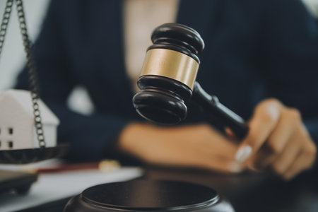 Judge gavel with Justice lawyers having team meeting at law firm background. Concepts of Law and Legal services.の写真素材