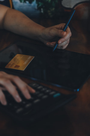 Hands holding credit card and using laptop. Online shoppingの写真素材