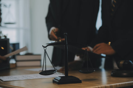 Consultation and conference of Male lawyers and professional businesswoman working and discussion having at law firm in office. Concepts of law, Judge gavel with scales of justice.の写真素材