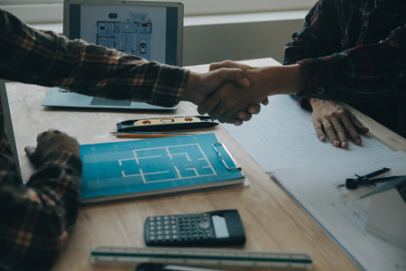 Professional Mechanical Engineer team Working on Personal Computer at Metal lathe industrial manufacturing factory. Engineer Operating lathe Machinery. Product quality Inspectionの写真素材