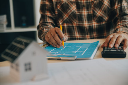 Professional Mechanical Engineer team Working on Personal Computer at Metal lathe industrial manufacturing factory. Engineer Operating lathe Machinery. Product quality Inspectionの写真素材