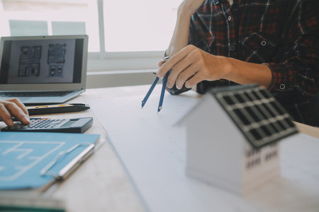 Professional Mechanical Engineer team Working on Personal Computer at Metal lathe industrial manufacturing factory. Engineer Operating lathe Machinery. Product quality Inspectionの写真素材