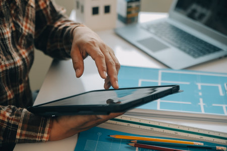 Professional Mechanical Engineer team Working on Personal Computer at Metal lathe industrial manufacturing factory. Engineer Operating lathe Machinery. Product quality Inspectionの写真素材