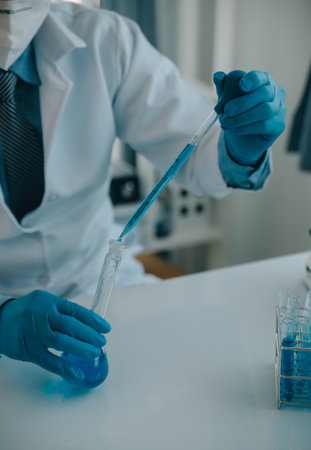 biochemical research scientist team working with microscope for coronavirus vaccine development in pharmaceutical research labolatory, selective focusの写真素材