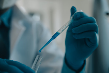biochemical research scientist team working with microscope for coronavirus vaccine development in pharmaceutical research labolatory, selective focusの写真素材