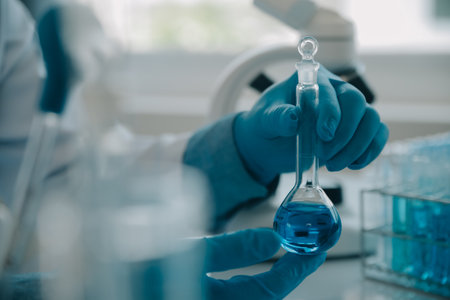 biochemical research scientist team working with microscope for coronavirus vaccine development in...