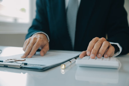 Closeup asian male people car salesman or sales manager offers to sell a car and explains and reads the terms of signing a car contract and insurance.の写真素材