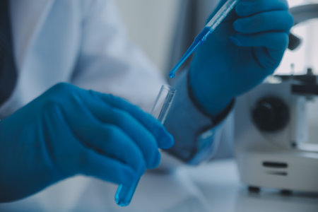 biochemical research scientist team working with microscope for coronavirus vaccine development in pharmaceutical research labolatory, selective focusの写真素材