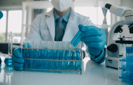 biochemical research scientist team working with microscope for coronavirus vaccine development in...